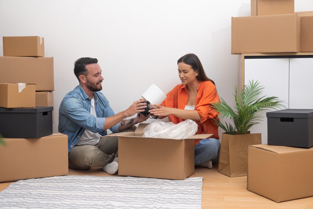 Couple unpacking their belongings together in a new home