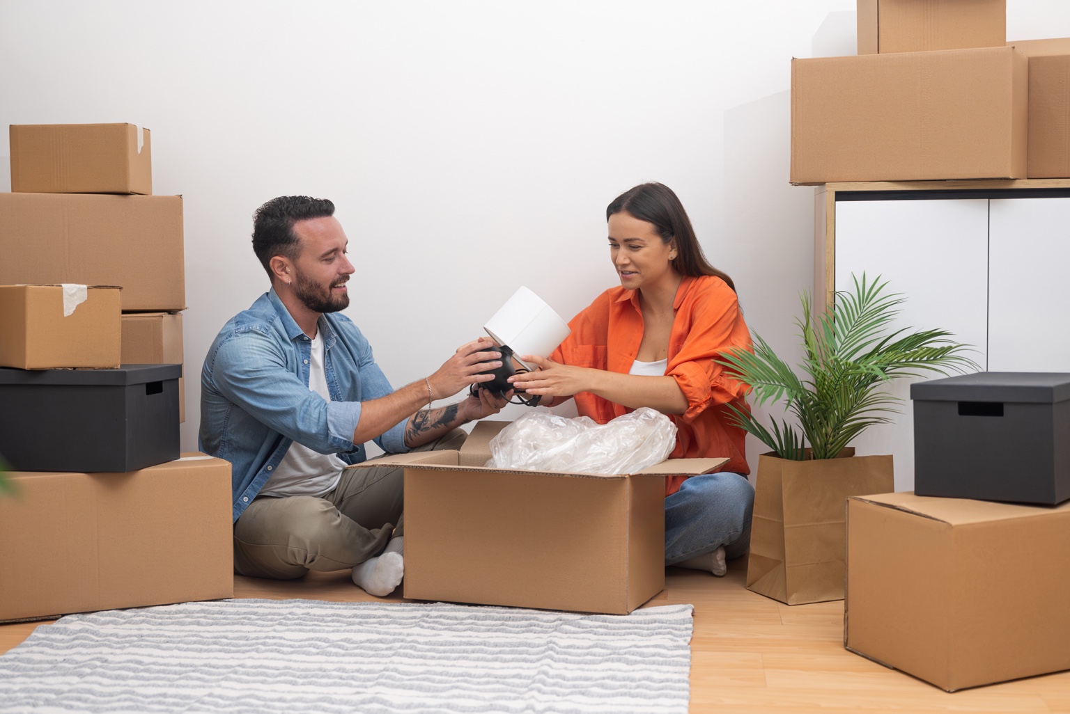 Couple unpacking their belongings together in a new home