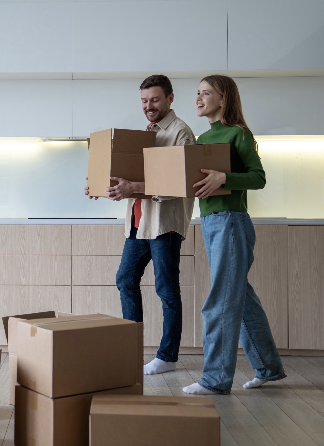Couple carrying boxes during a home move
